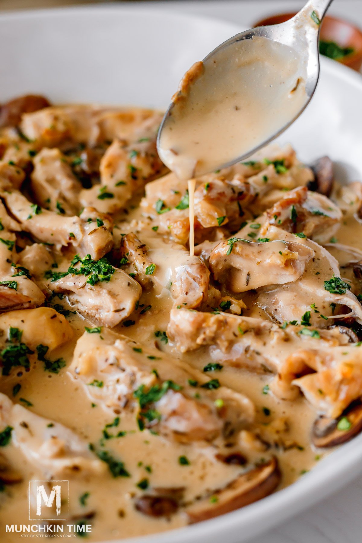 Creamy sauce pouring over Chicken Mushroom Recipe