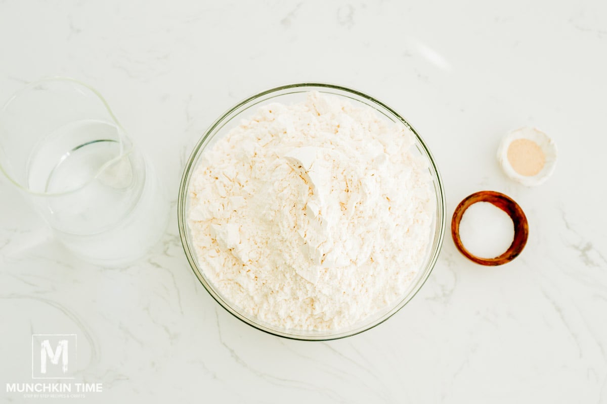 ingredients on the table: flour, water, dry active yeast and salt