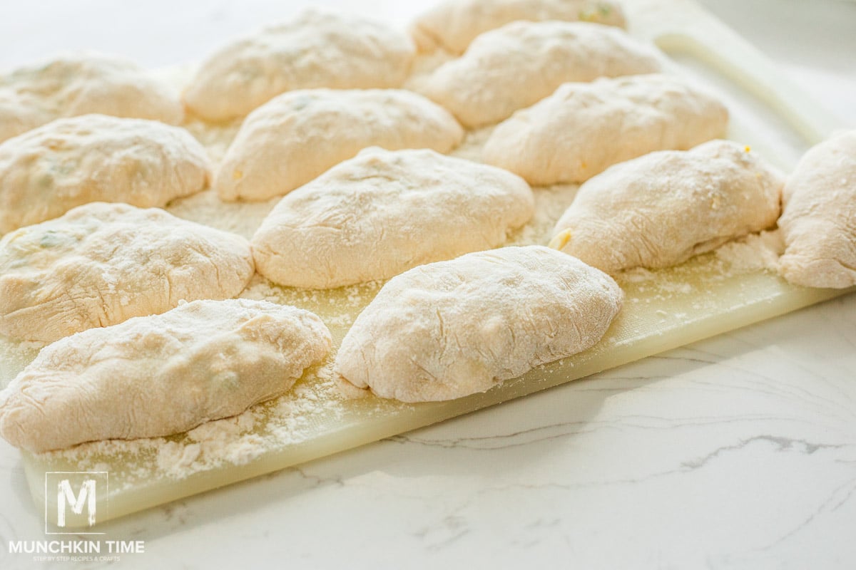 raw piroshki on a cutting board