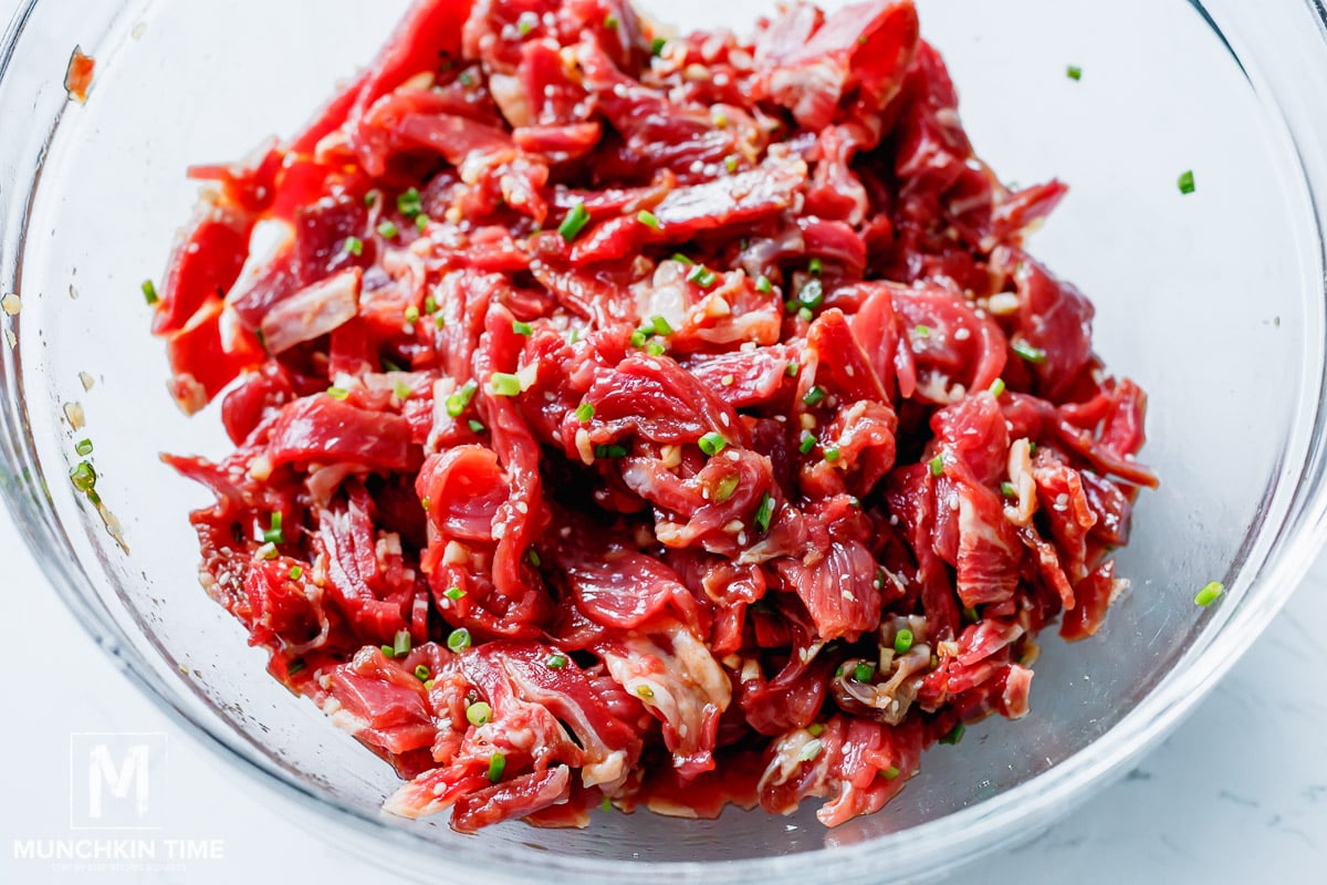 rib eye cut into strips marinating 