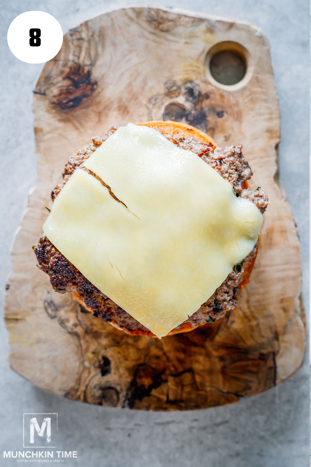beef patty with melted cheese added to the bun.