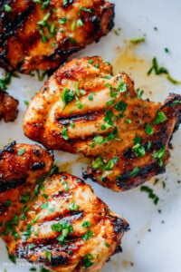 chicken shawarma after grilling on a plate garnished with parsley.