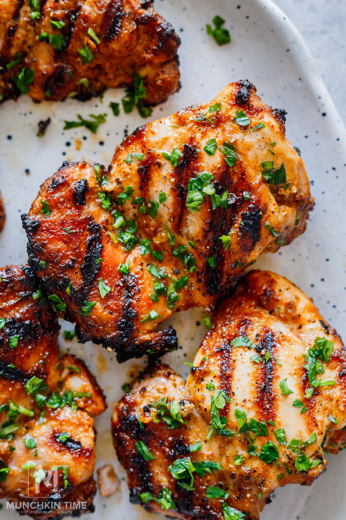 grilled chicken thighs shawarma garnished with parsley.