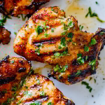 chicken shawarma after grilling on a plate garnished with parsley.