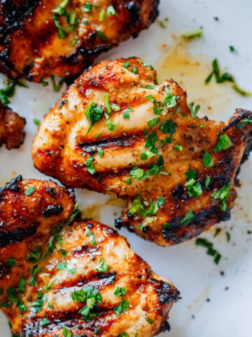 chicken shawarma after grilling on a plate garnished with parsley.