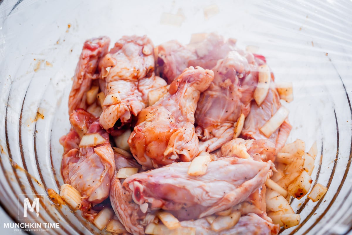 chicken in a bowl marinating