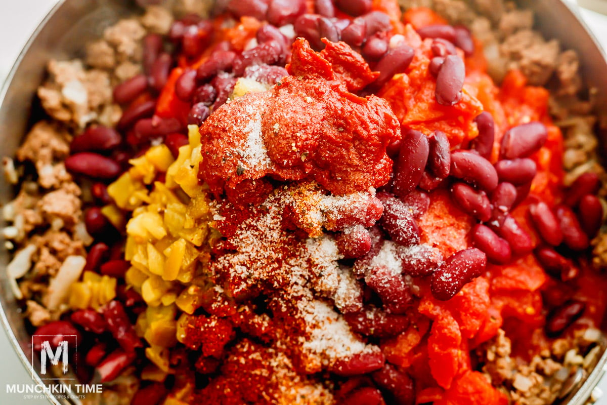 skillet full of beef beans tomatoes spices and chili peppers 