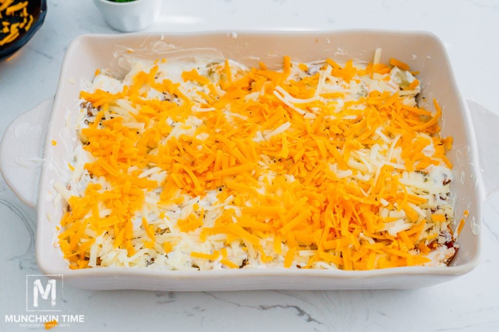 grated cheese over potatoes