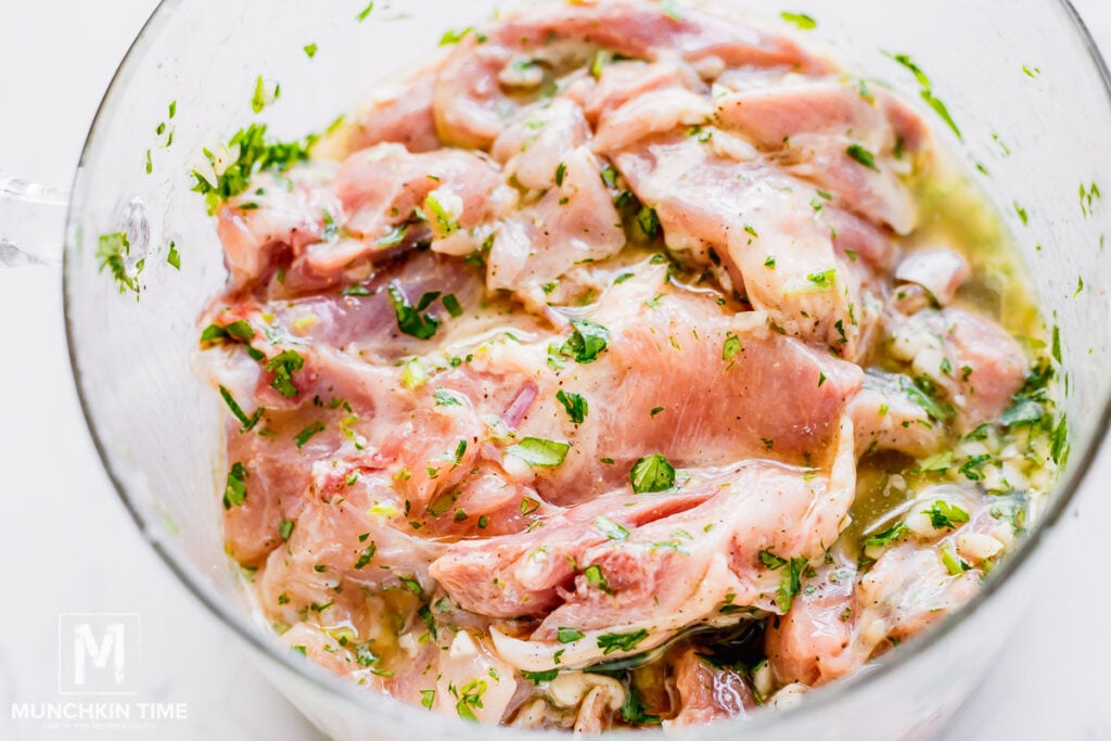 chicken meat marinating in a pot