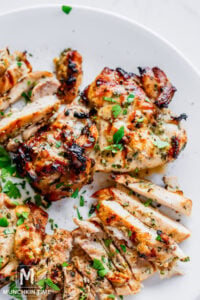 perfectly grilled chicken on the plate garnished with cilantro