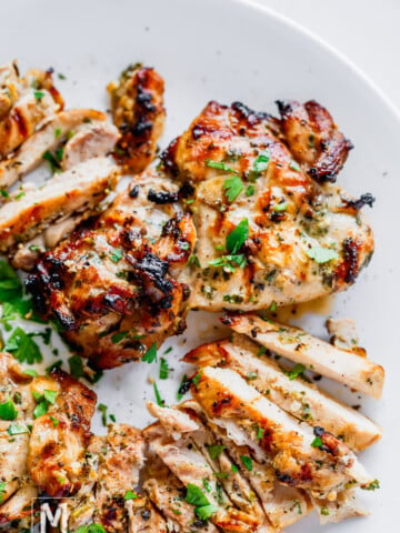 perfectly grilled chicken on the plate garnished with cilantro