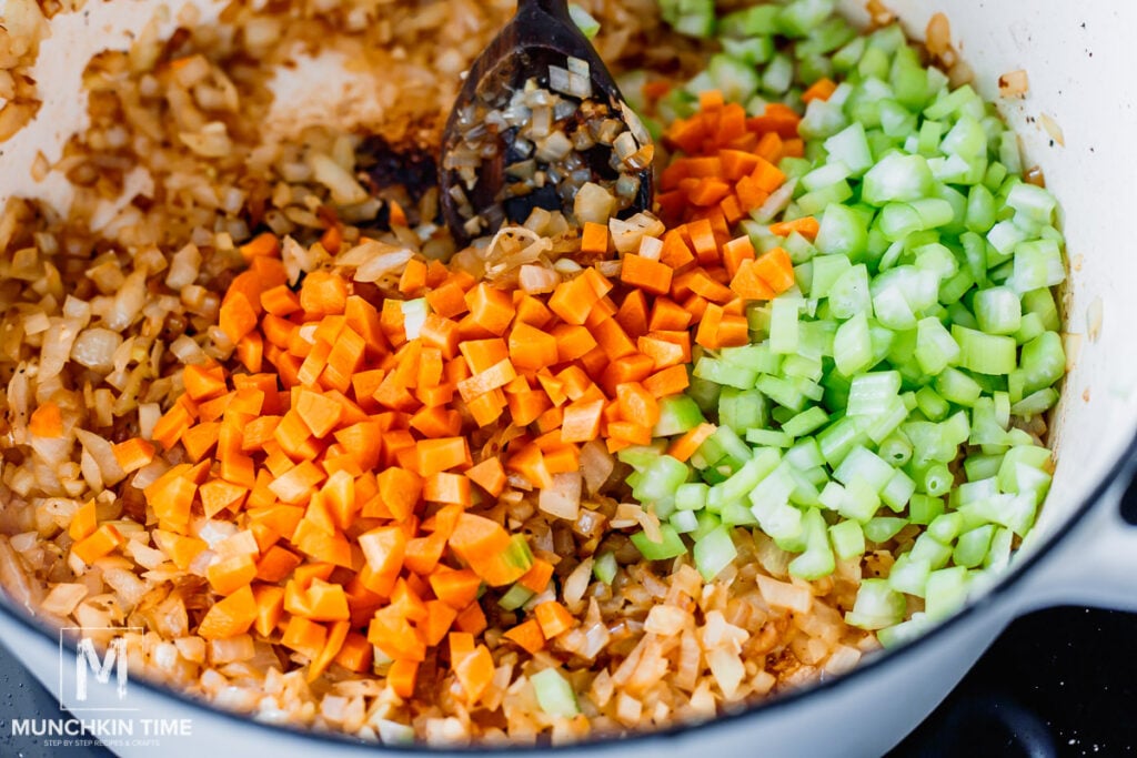 carrot and celery added to the pot with onion