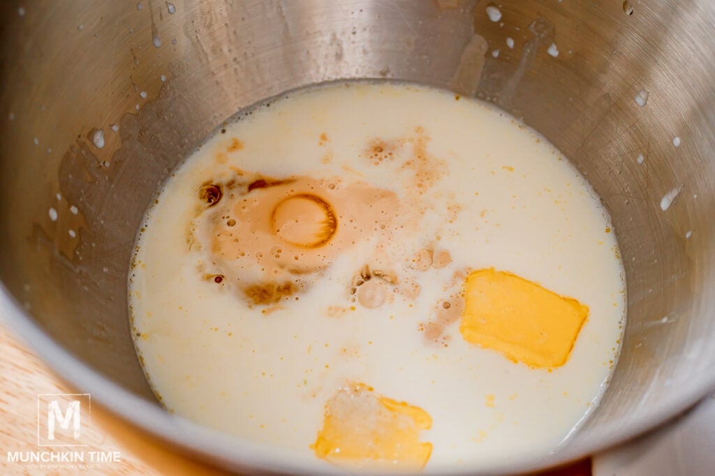 active yeast in a stand mixer bowl with butter and warm milk.