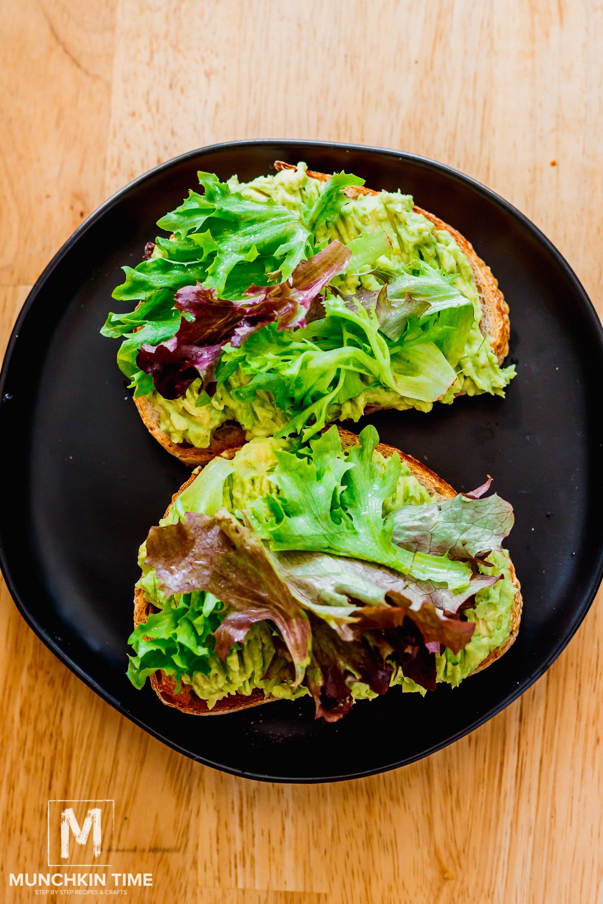 greens added to the avocado spread over the bread