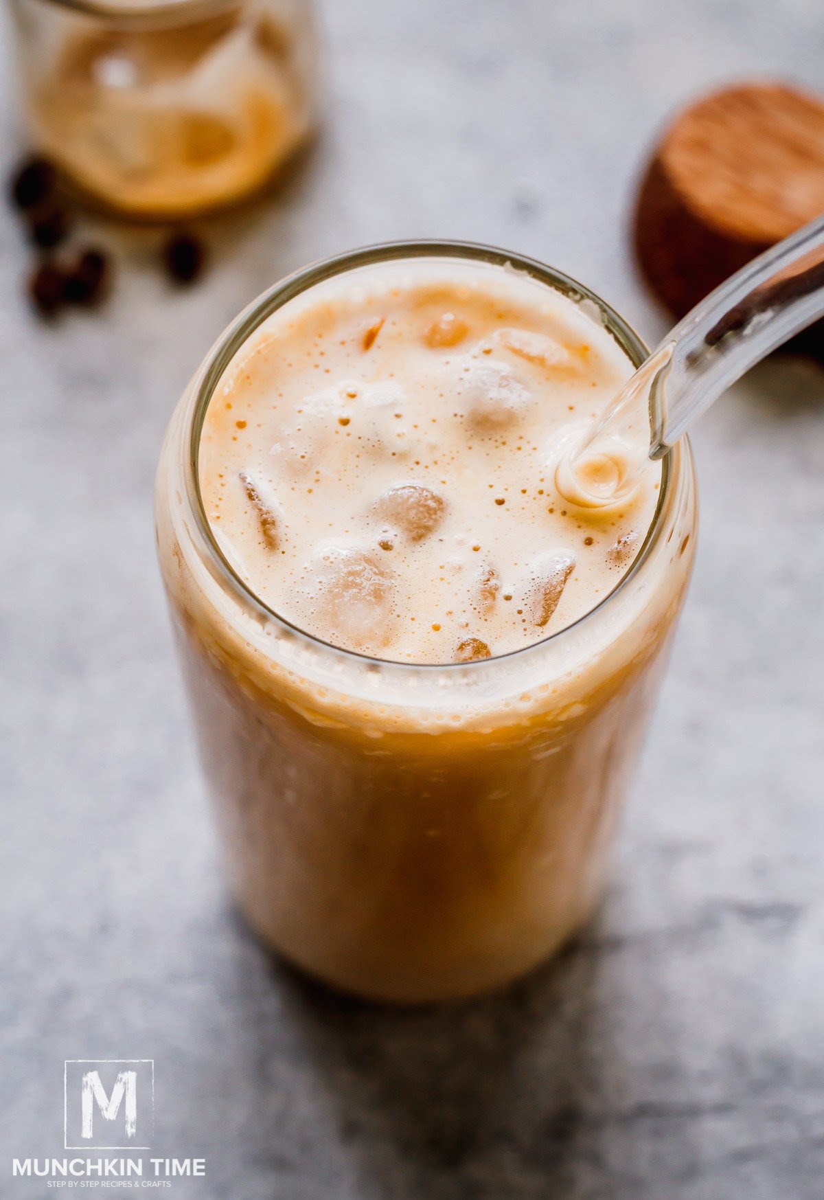 Refreshing protein iced coffee in a tall glass with glass straw.