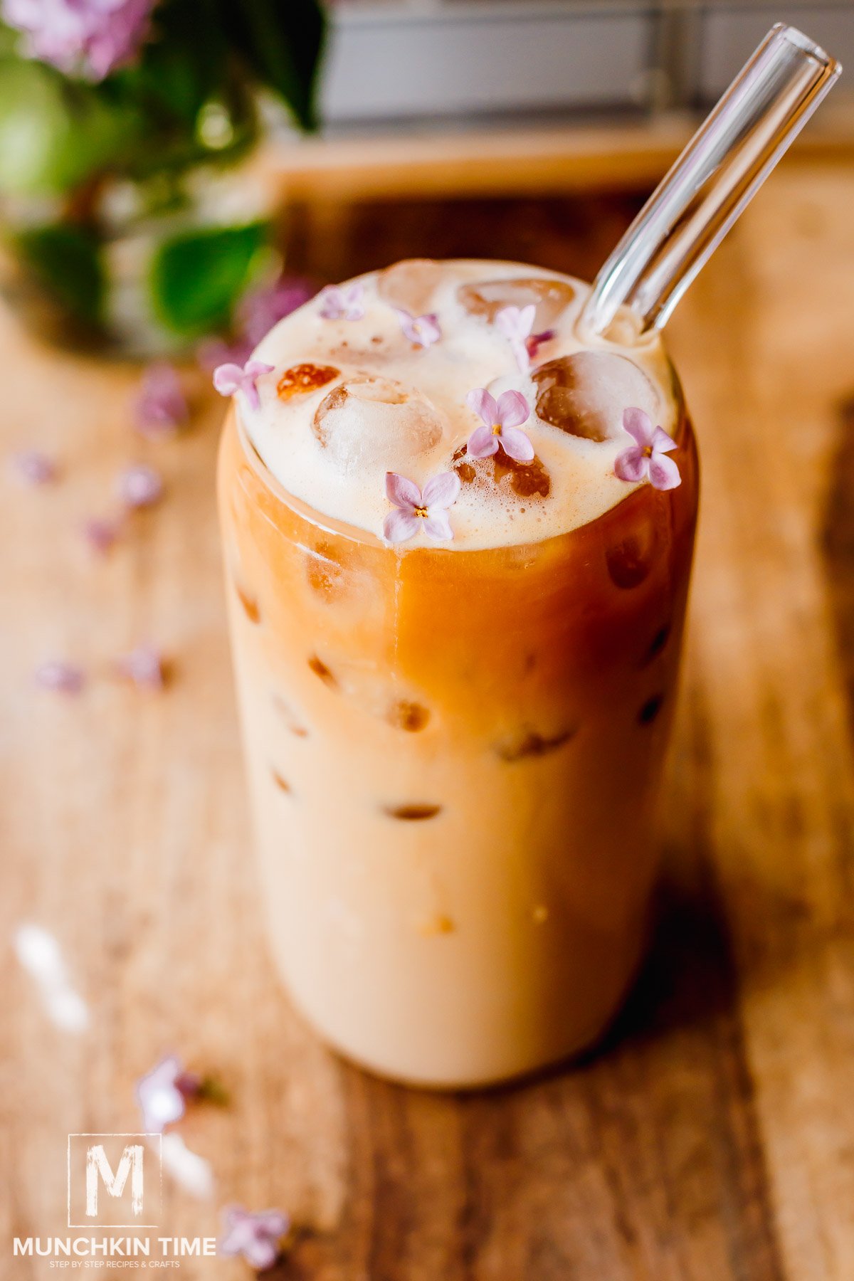 Protein Coffee with ice in a tall glass with glass straw.