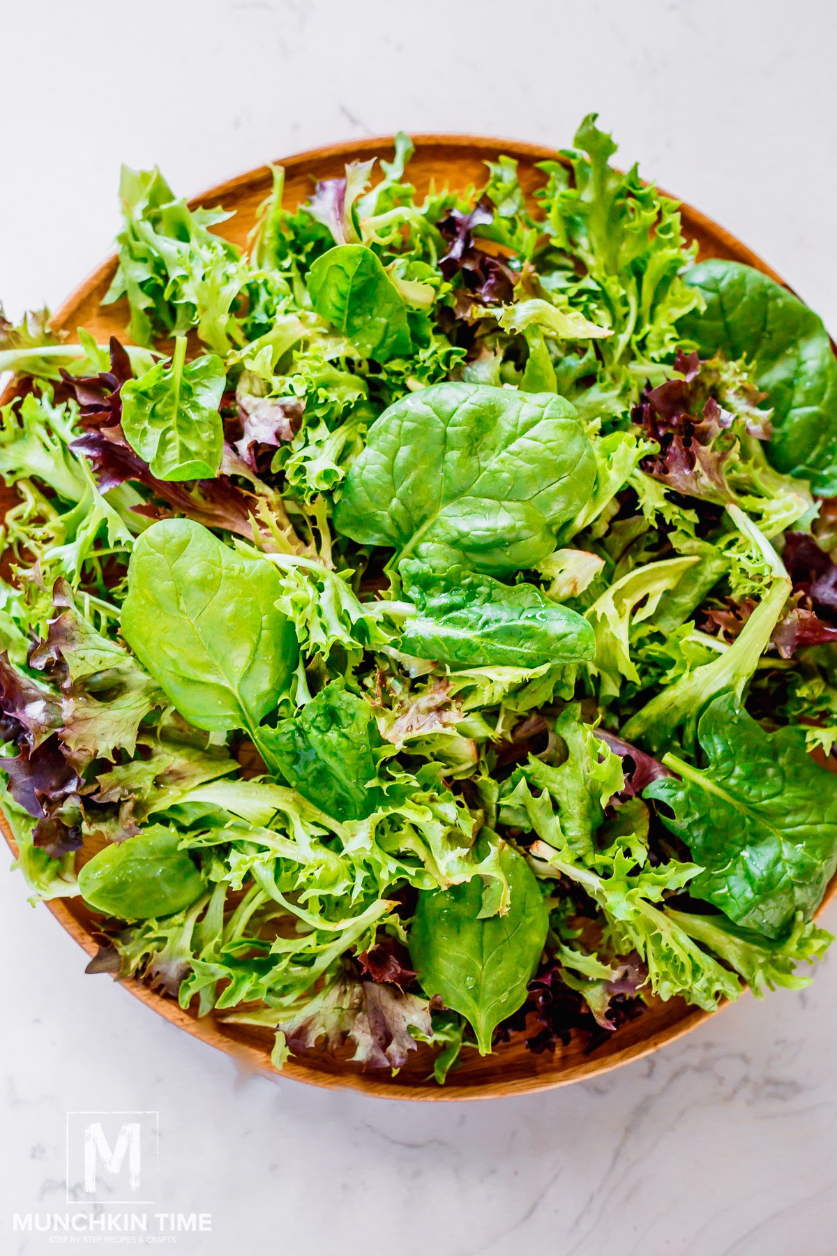 spinach and other greens on a big salad plate.