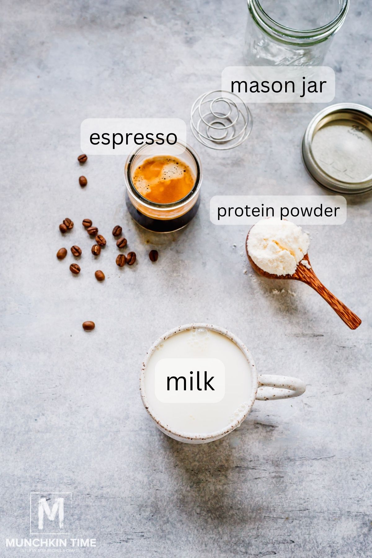 milk with 2 shots of espresso and protein powder on the table.