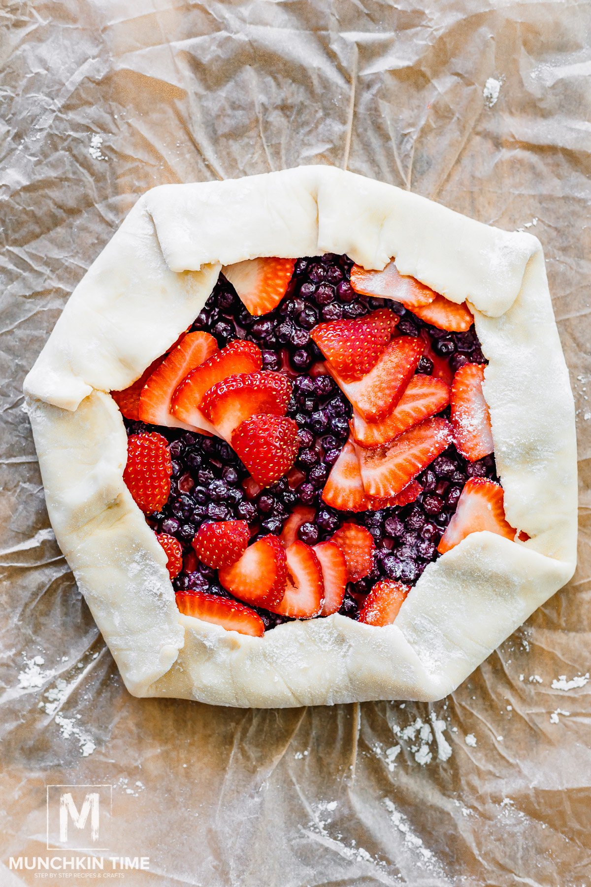 Unbaked strawberry and blueberry galette ready to be brushed with egg wash.