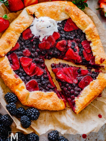 Freshly baked strawberry galette made with sourdough discard sliced with ice cream on top.