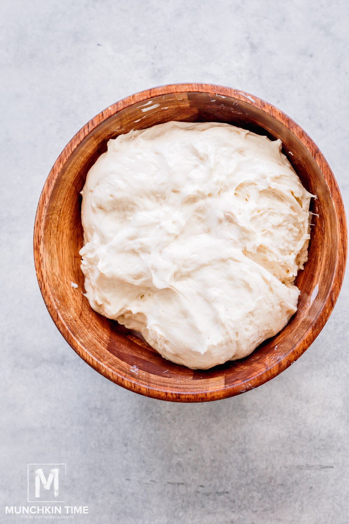 Sourdough Pizza dough is kneaded in a bowl.
