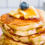 maple syrup pouring down a Sourdough Discard Pancake stack.