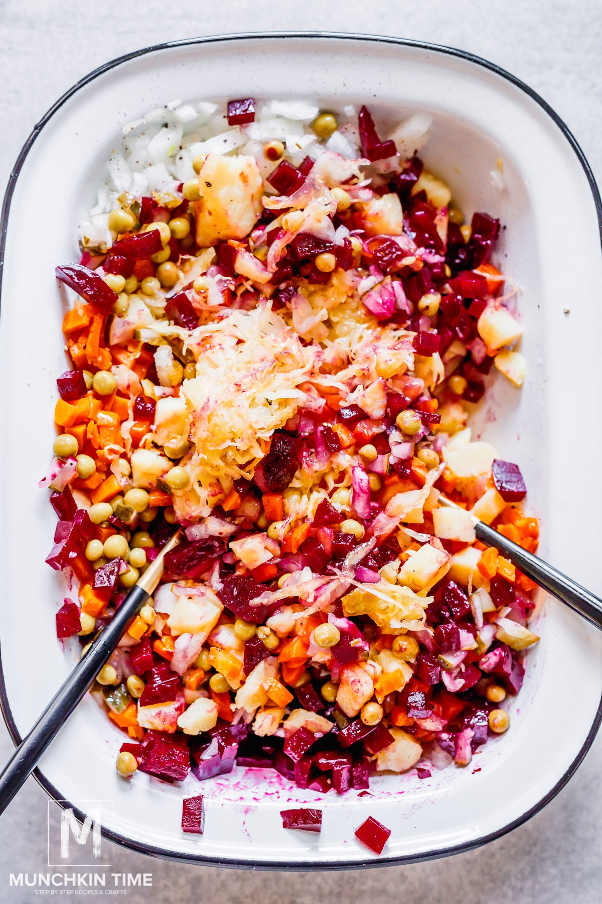 The Best Russian Potato Salad with Beets with no mayo being mixed in a bowl.
