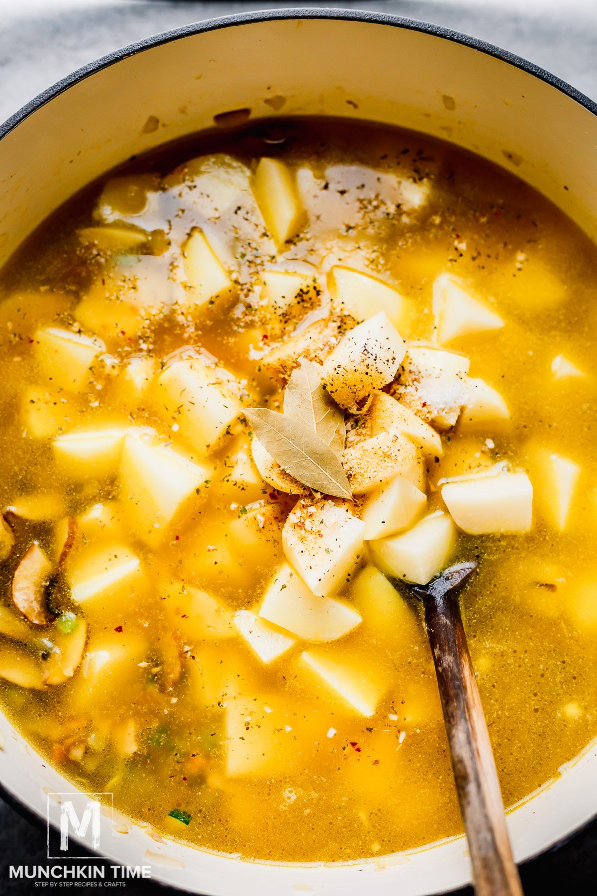 Chicken broth added to the pot with cubed potatoes and spices.