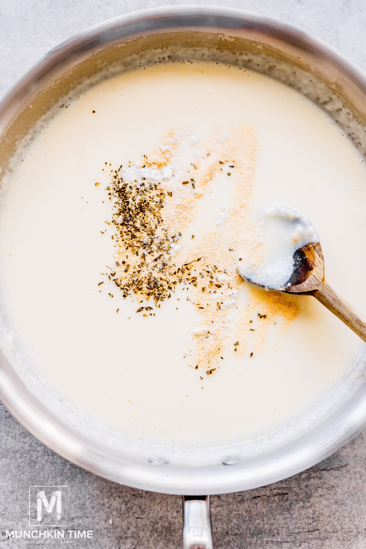 seasoning added to the creamy sauce in the skillet.