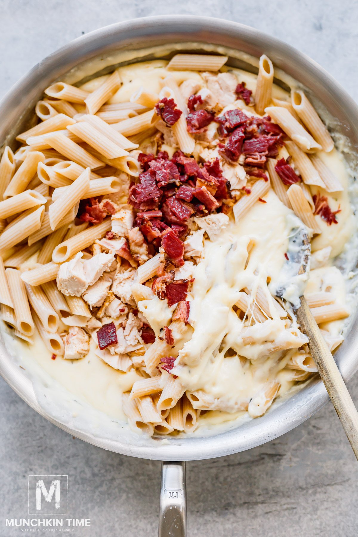 Cooked pasta, chicken and bacon added to the mac and cheese sauce.