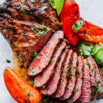 carne asada steak sliced on a cutting board and ready to be served.