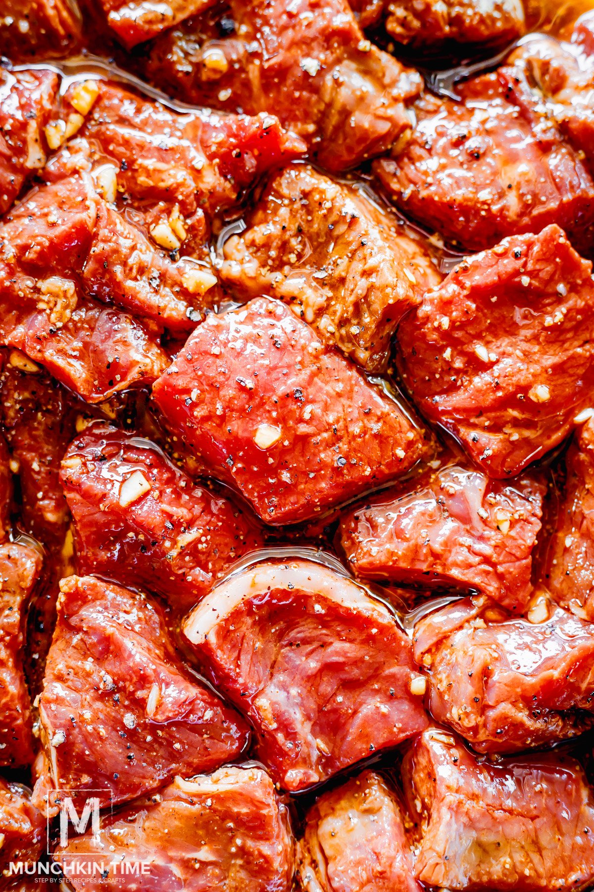 sirloin steak cubes mixed with marinade in a bowl.