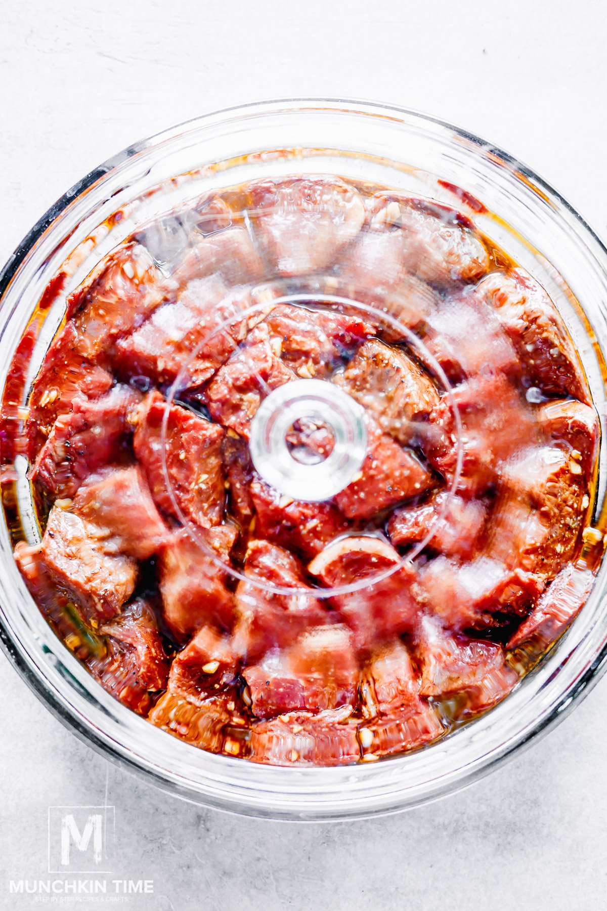 meat with marinade covered with a lid.