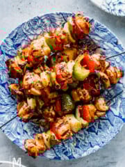 Perfectly Grilled Lemon Garlic Chicken Thighs Skewers on a blue plate.
