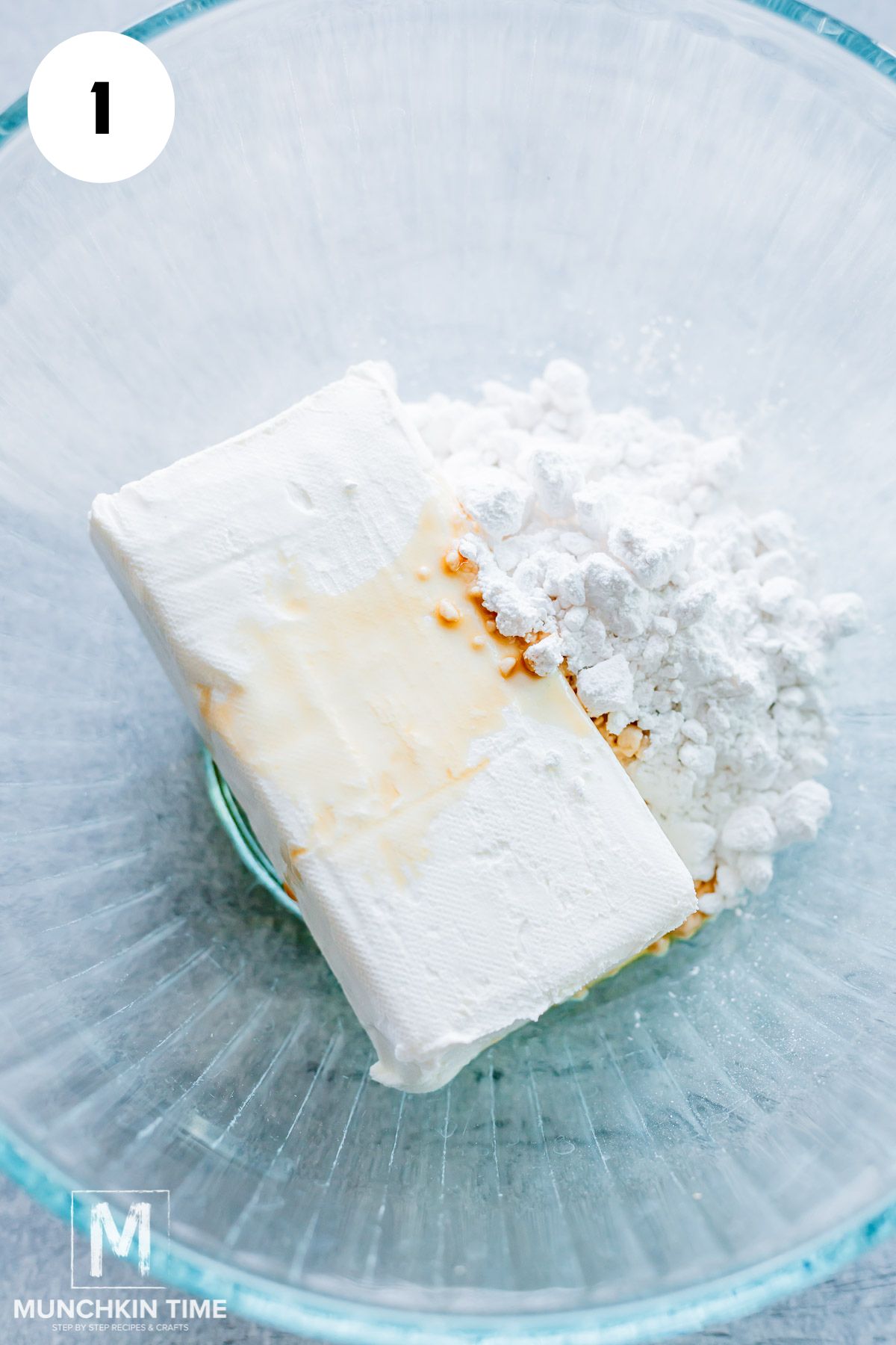 cream cheese and powdered sugar in a bowl with vanilla extract.