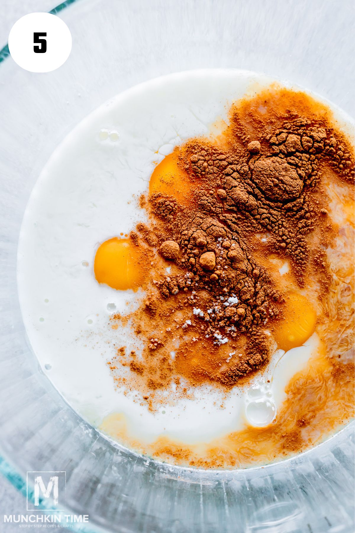 milk eggs salt and cinnamon added to the bowl.