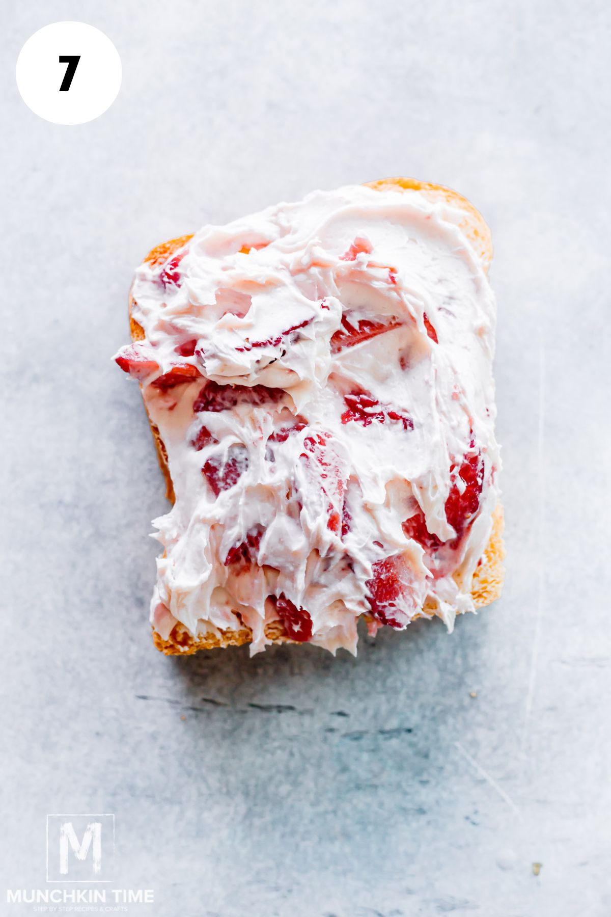 strawberry with whipped cream cheese added to the sliced bread.