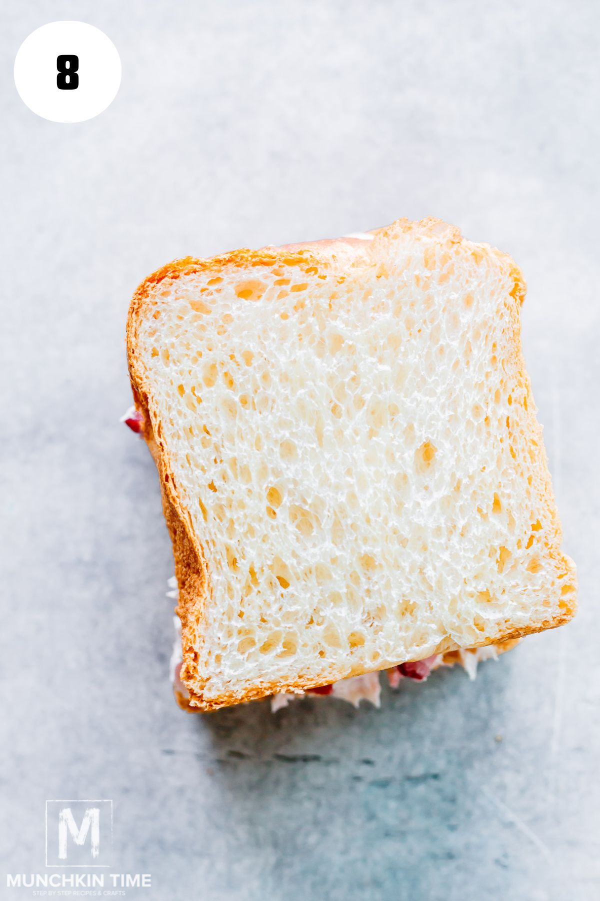 bread sliced on top of the bread with cream cheese.