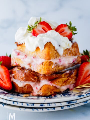 Strawberry Stuffed French Toast with cream cheese with sliced strawberries on the top.