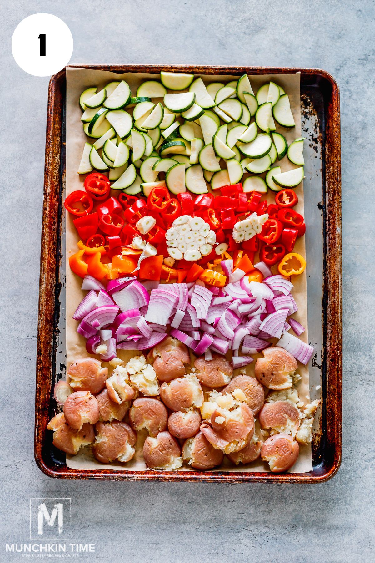 Arrange all of the vegetables, including the head of garlic, on a baking sheet, being careful not to overlap them. If they don’t all fit in a single layer, you may need to use two sheets.