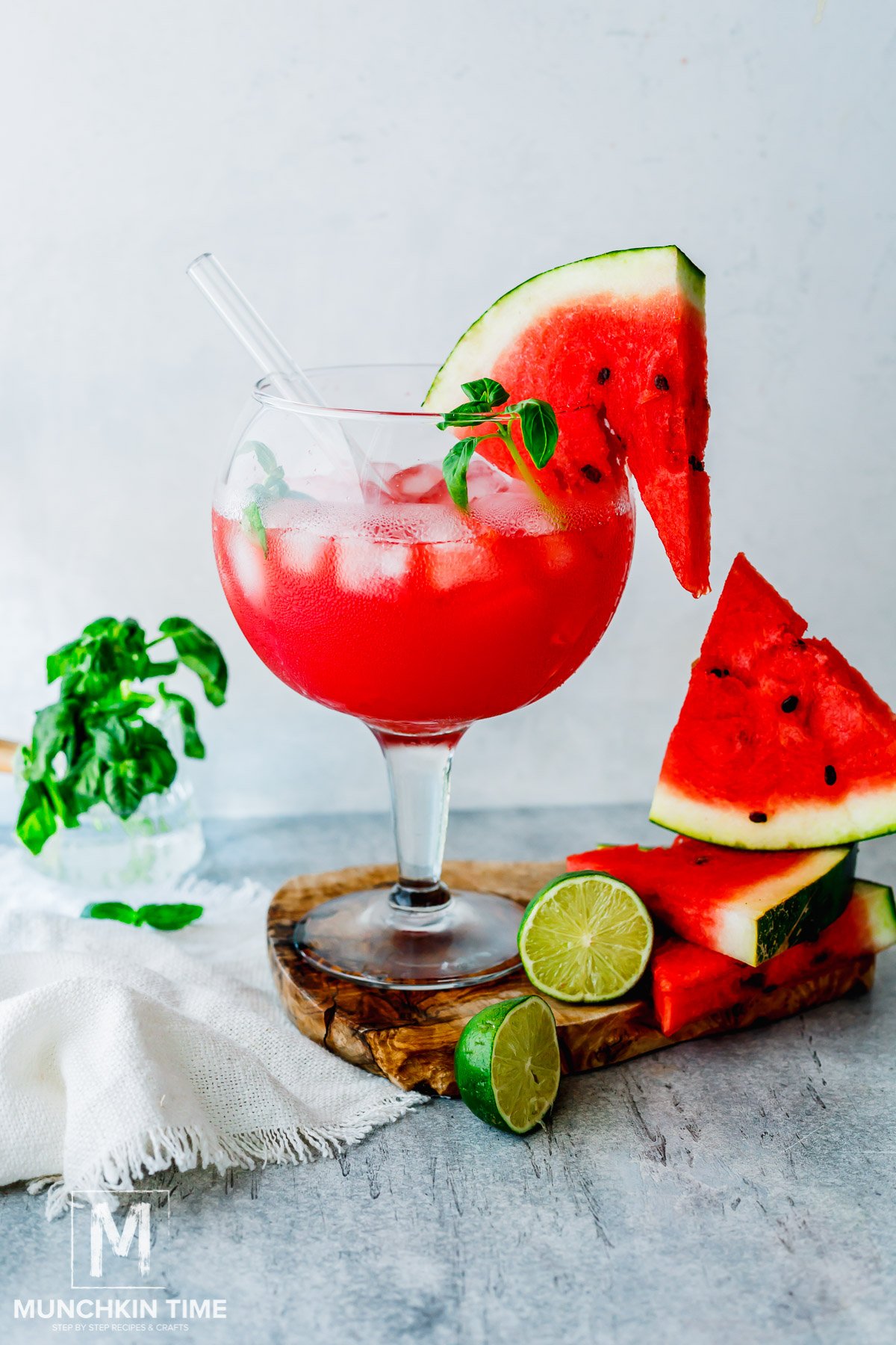 iced watermelon juice garnished with watermelon slice and basil.