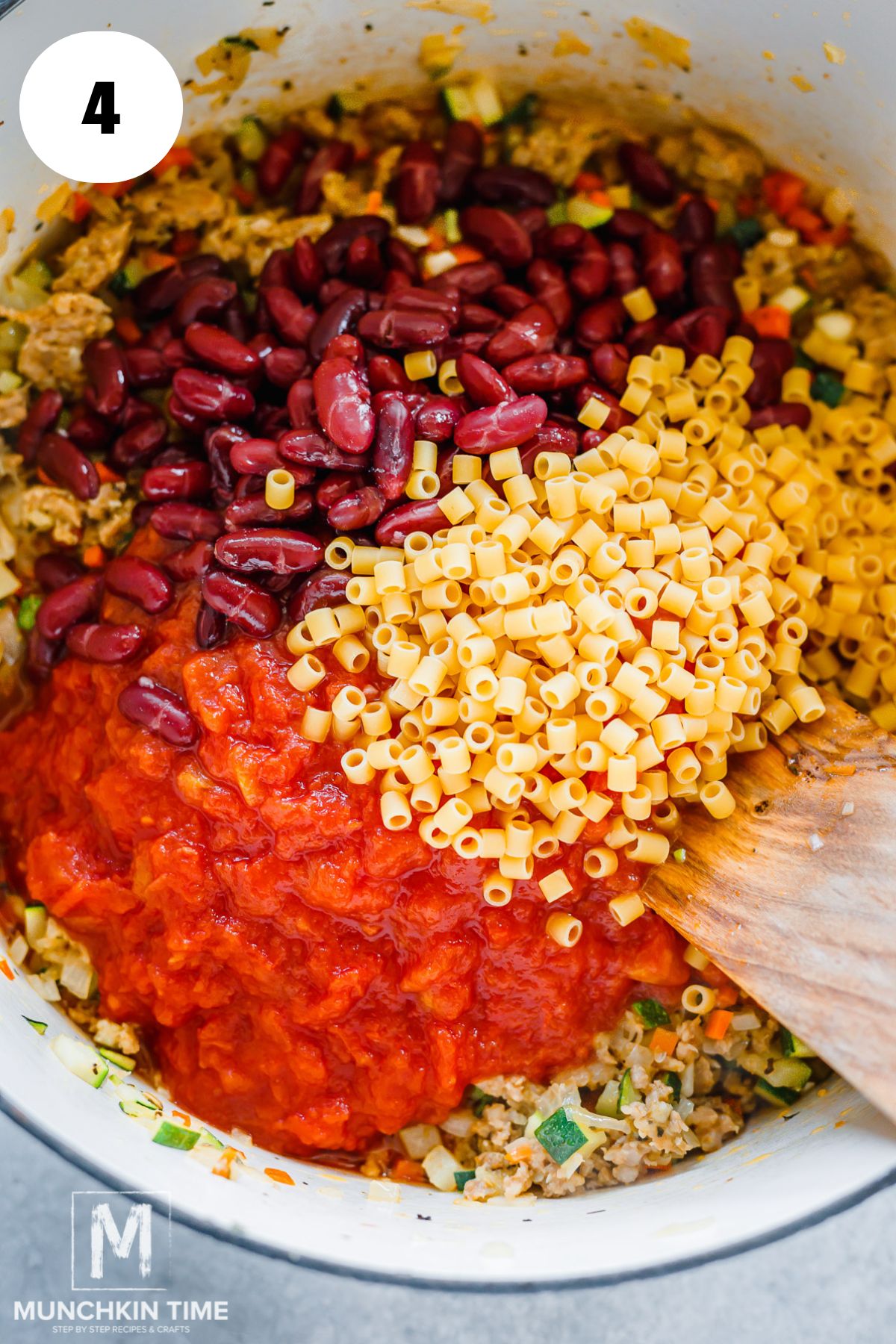tomatoes, beans and pasta added to the dutch oven.