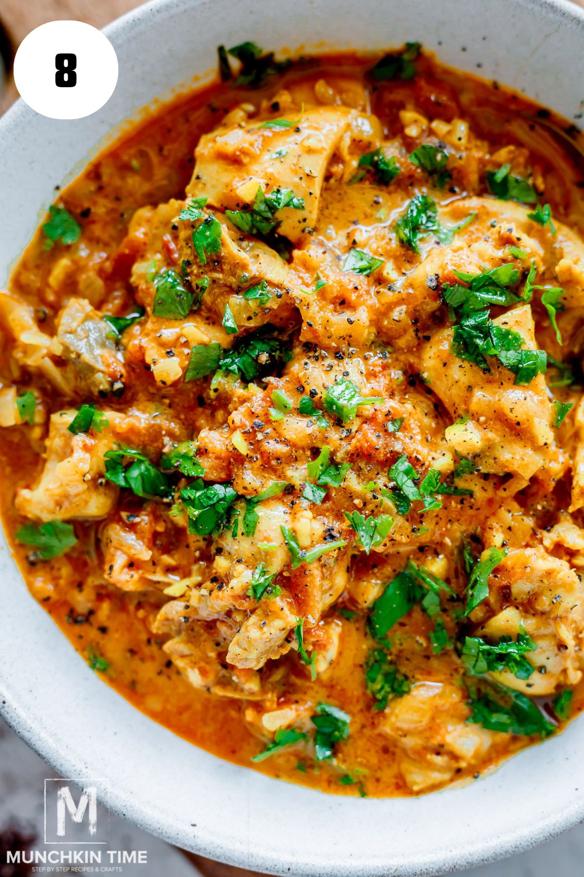 creamy chicken tikka masala in a bowl garnished with cilantro.