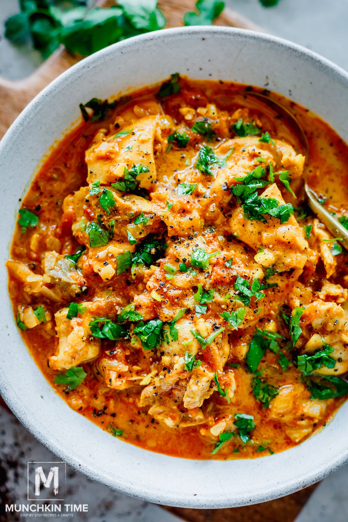 creamy chicken tikka masala in a bowl garnished with cilantro.