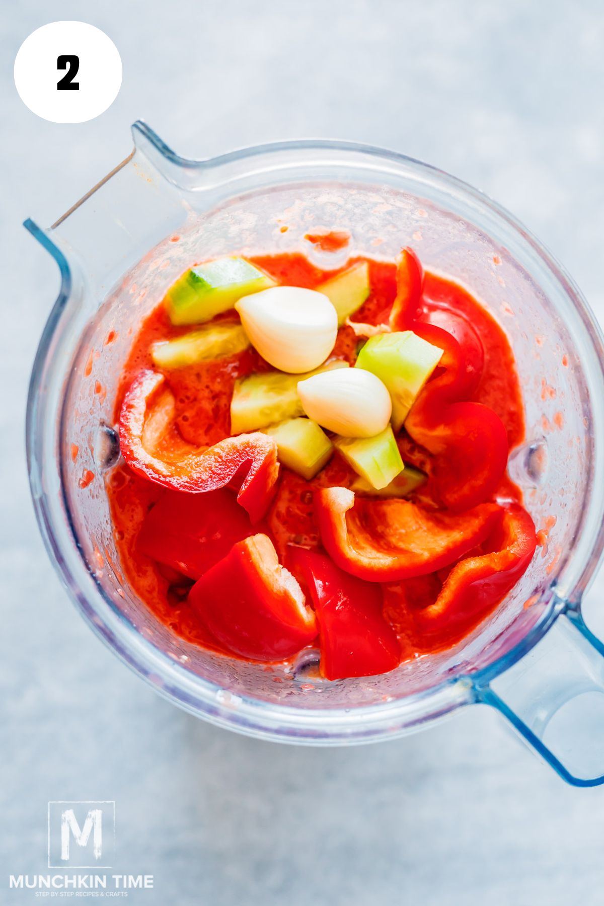 sliced tomatoes with cucumber garlic and bell pepper in a blender.