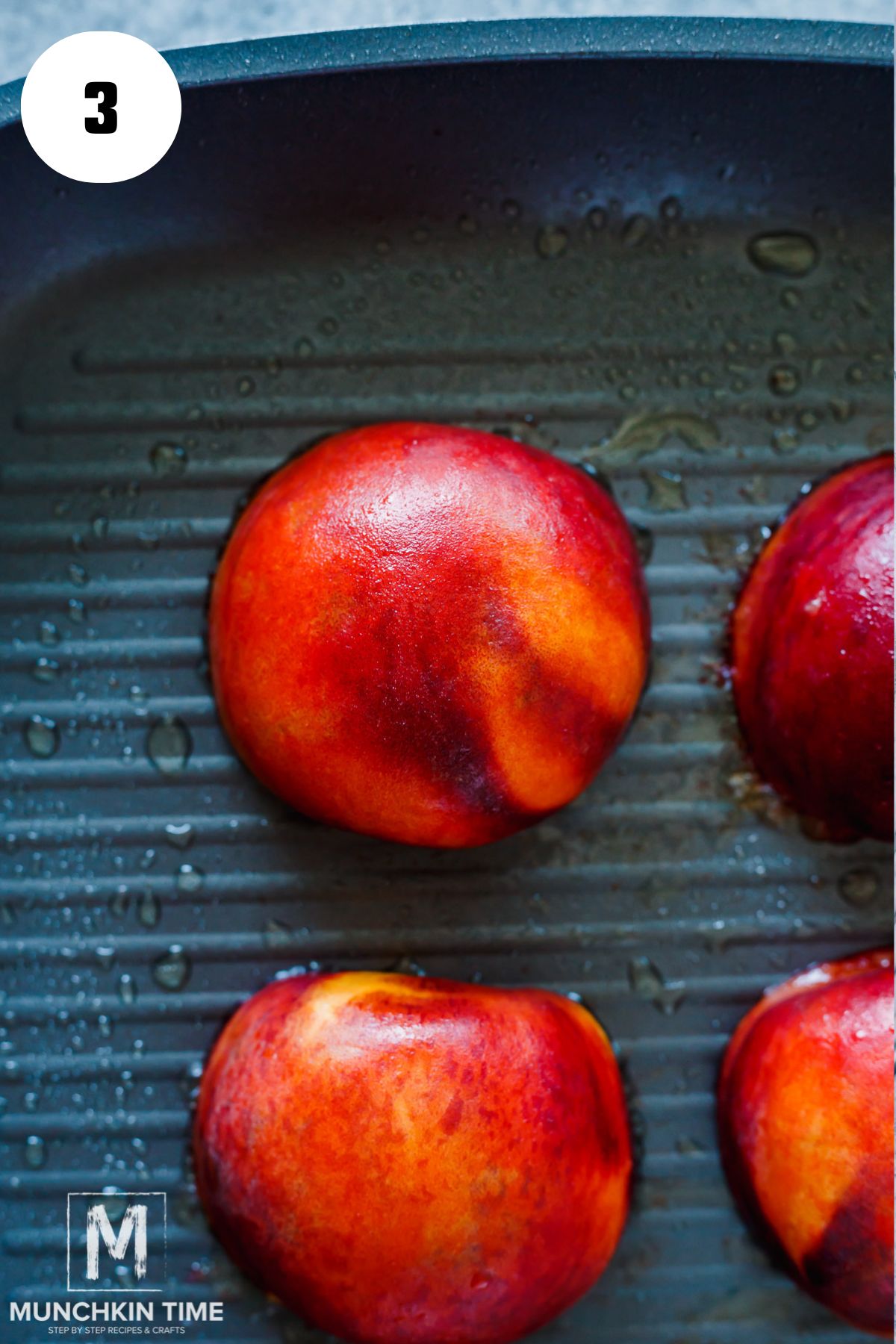 peaches cut side down on a grilling pan.