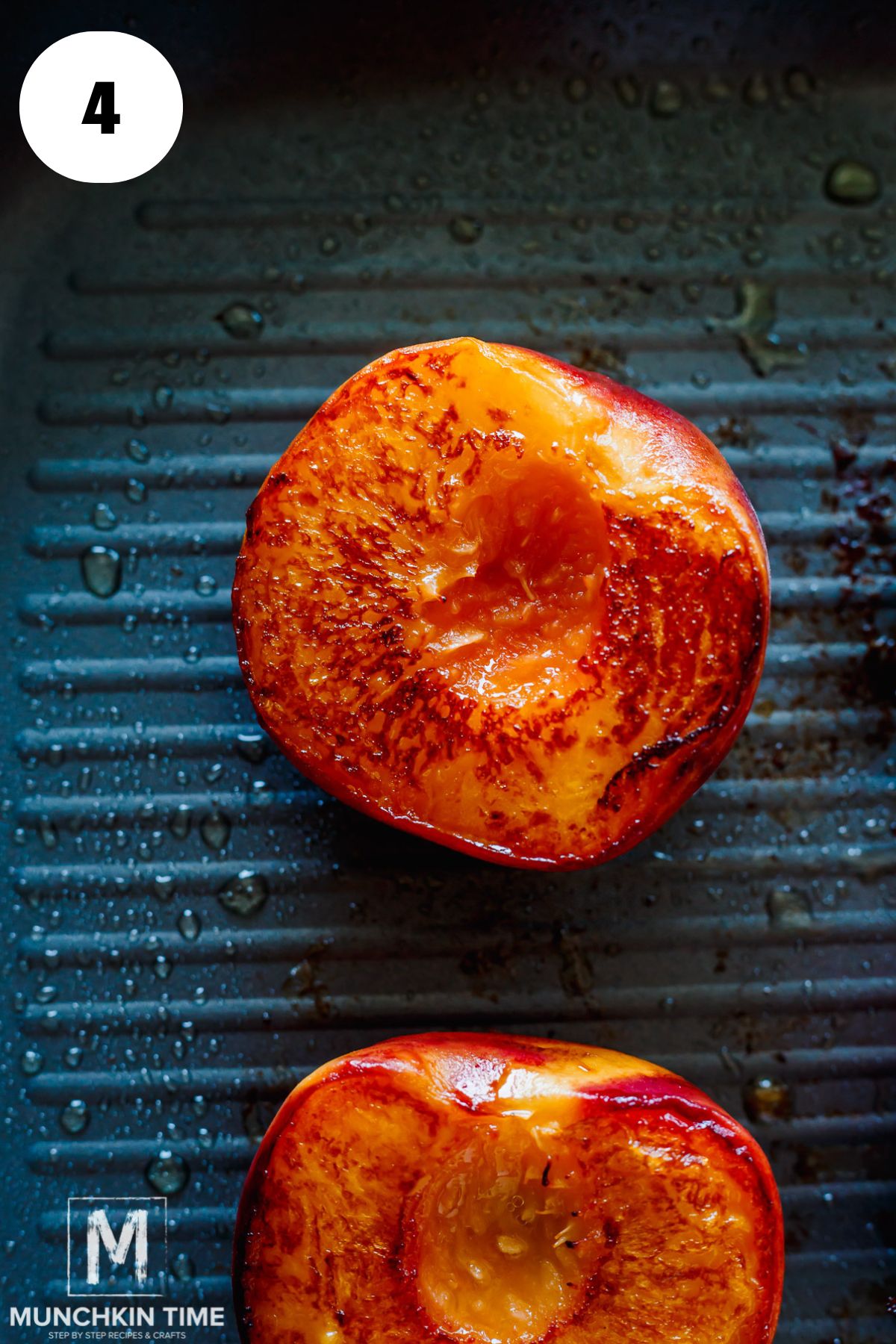 grilled peach cut side up on a grilling pan.