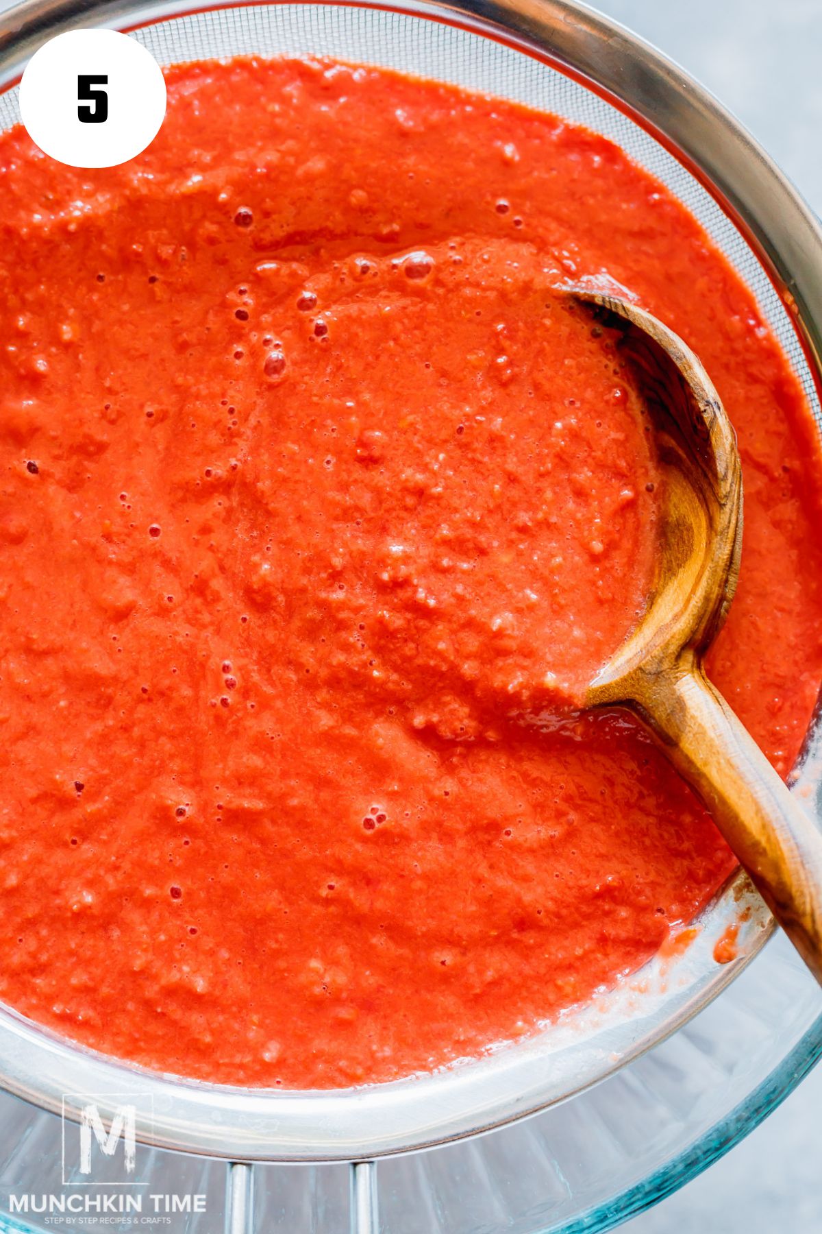 tomato mixture in a fine strainer.