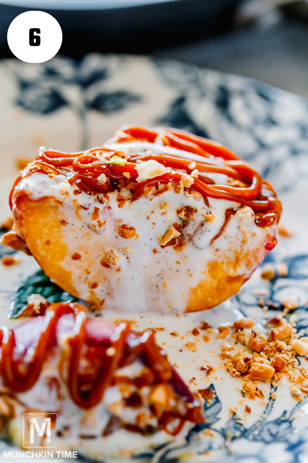 Grilled Peaches with Ice Cream and chopped nuts cut in half.