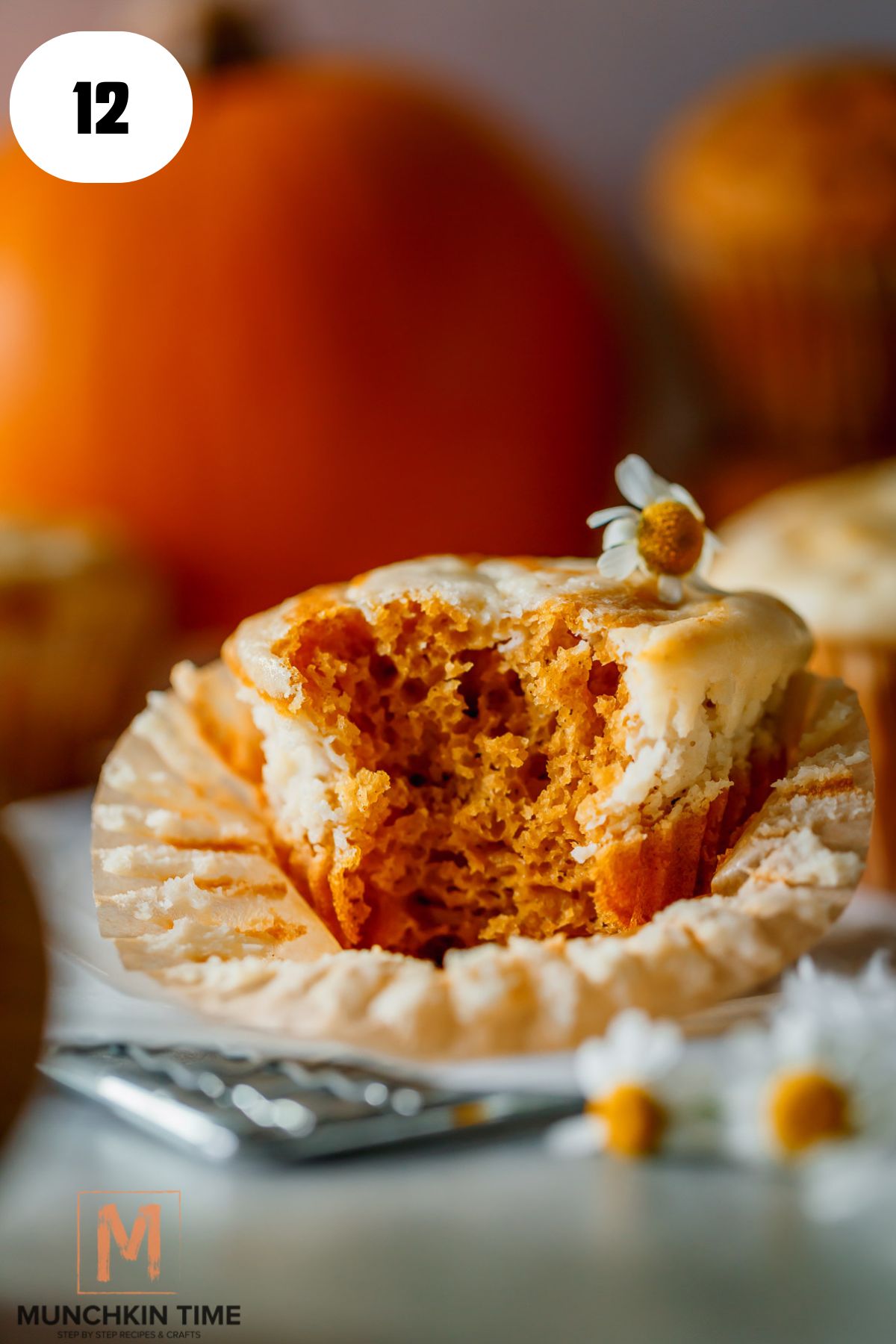 a bitten of sourdough pumpkin muffins with cream cheese filling.